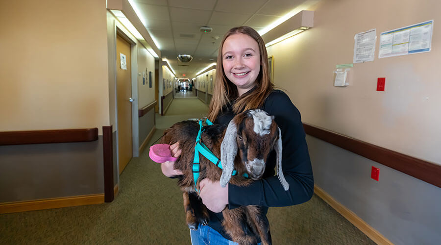 Peyton Marquardt brings goat to Good Samaritan Society - Lakota for intergenerational entertainment.